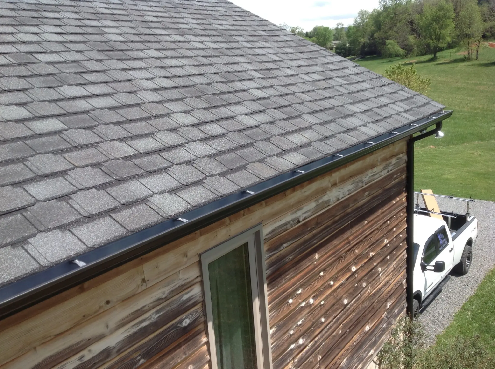 Dark bronze gutters and designer asphalt shingles