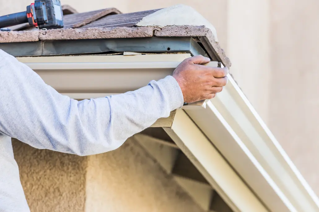 worker installing gutters