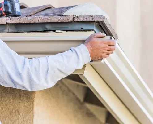 worker installing gutters