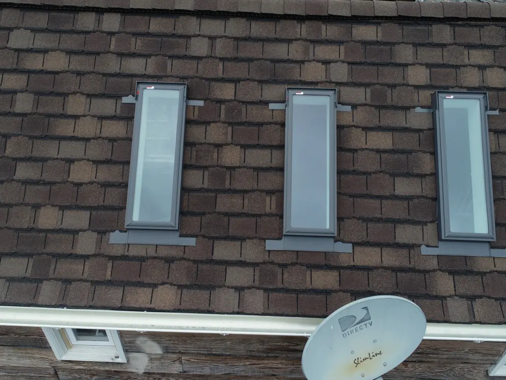 DJI_0400-2048x1536 Three rectangle skylights on a roof.