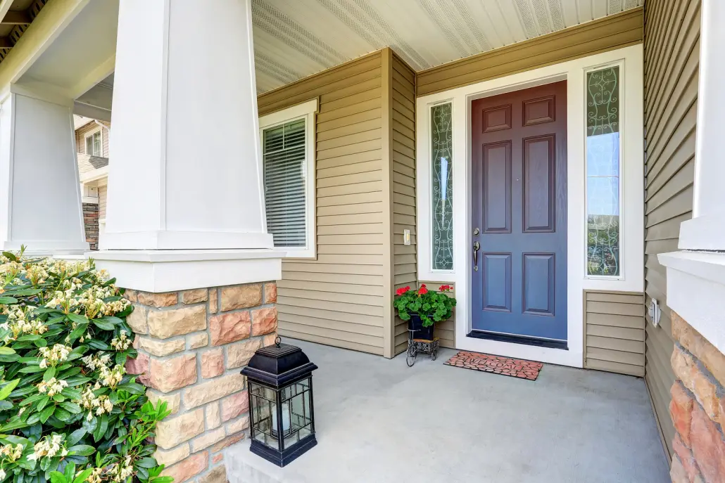 Front Entry Door With Concrete Floor Porch And Flowers Pot Front door and porch of a house.