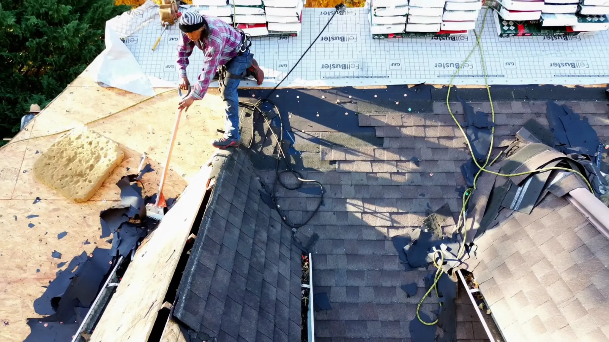 Ziembas2 Roofer on top of home removing old shingles.