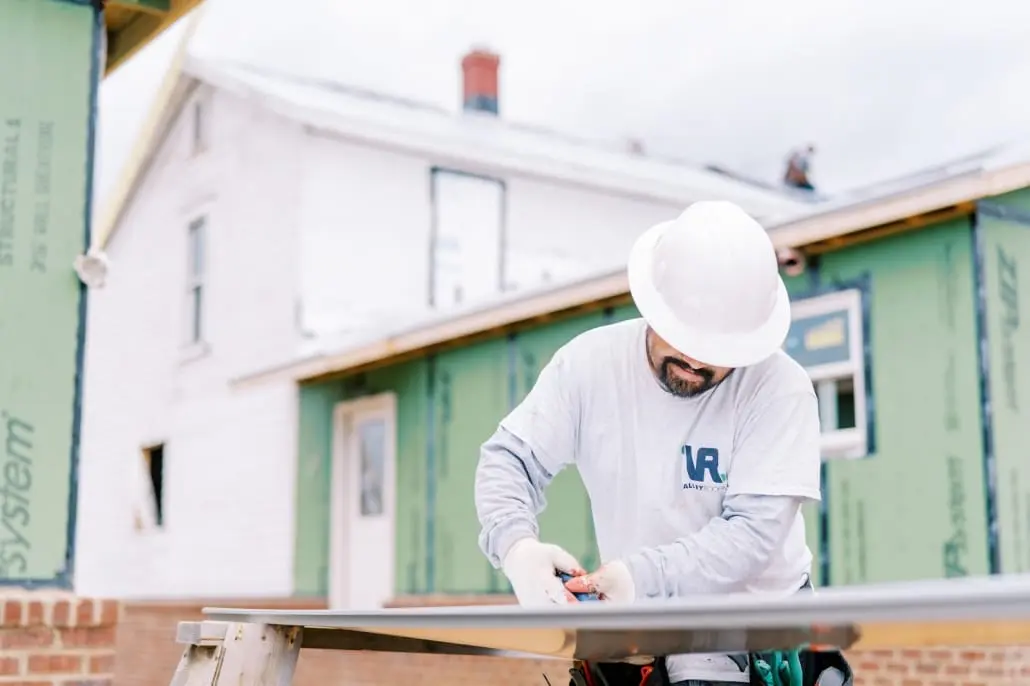 Warranty1 Roofers cutting material for metal roofing project on-site at Staunton home