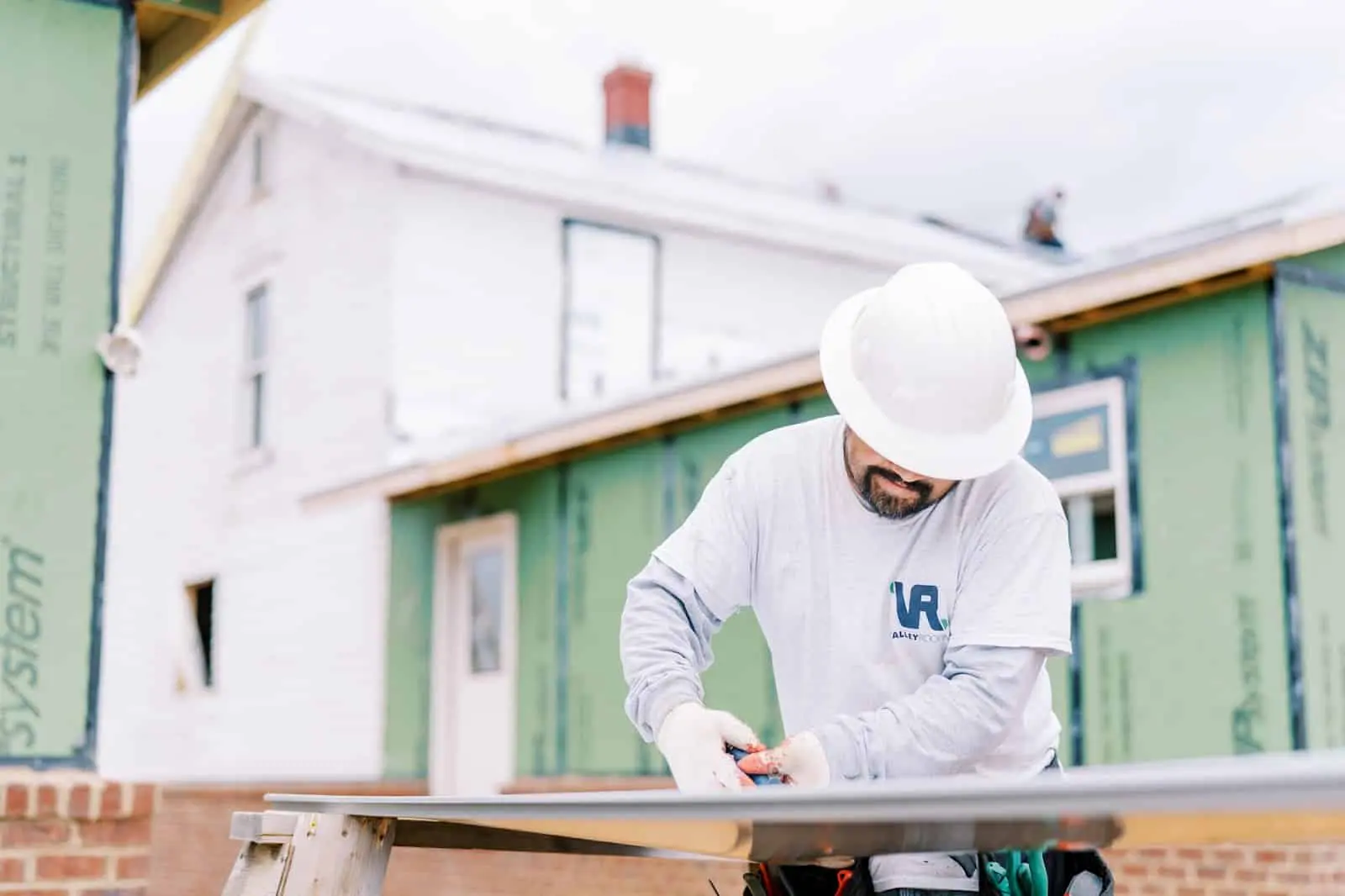 Warranty1 Roofers cutting material for metal roofing project on-site at Staunton home