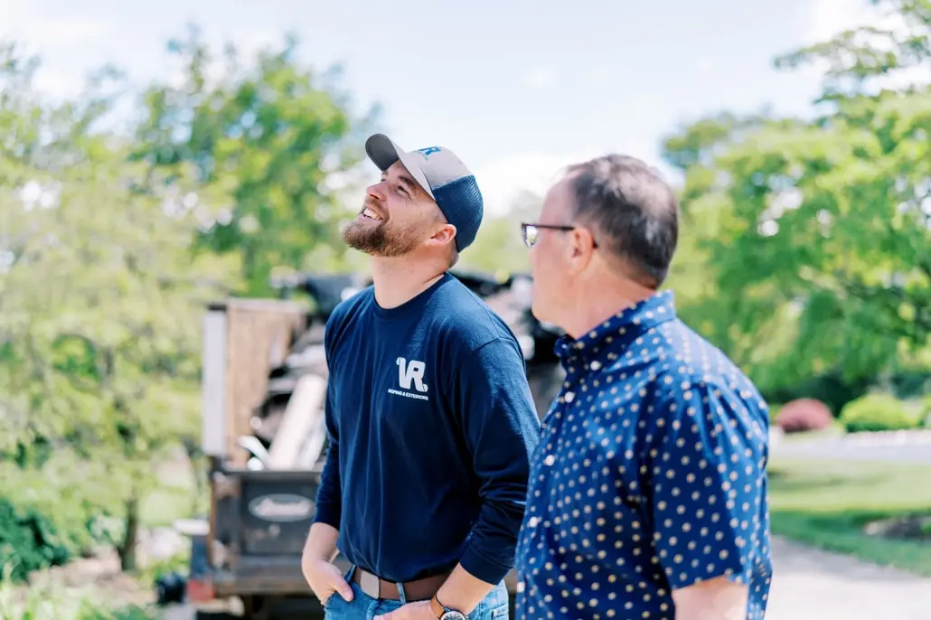 client discussing options with sales rep during a consultation with roofing company, Valley Roofing & Exteriors