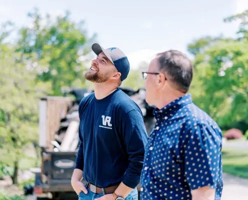 client discussing options with sales rep during a consultation with roofing company, Valley Roofing & Exteriors