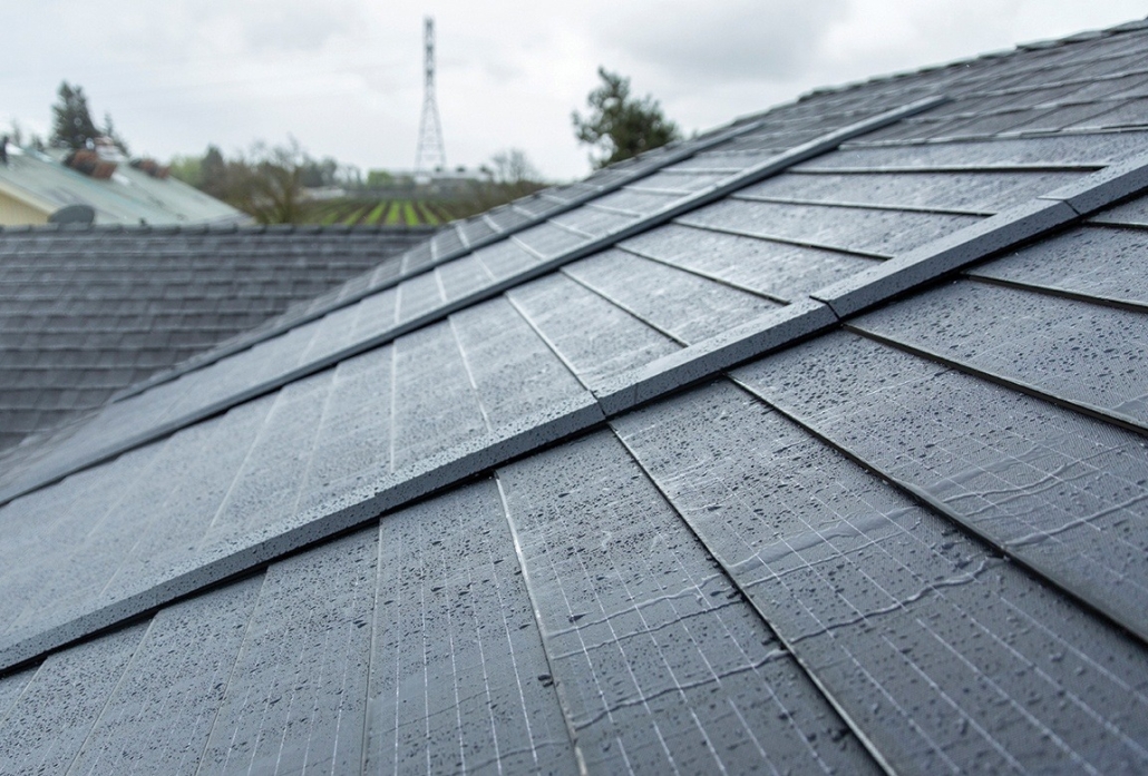 up close shot of timberline solar shingles with rain drops on them.