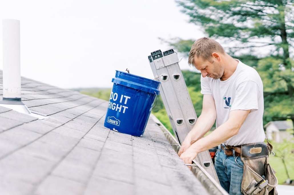 man cleaning gutters