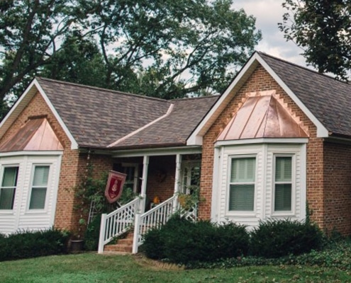 example of copper roofing mixed with asphalt shingles in one roof system