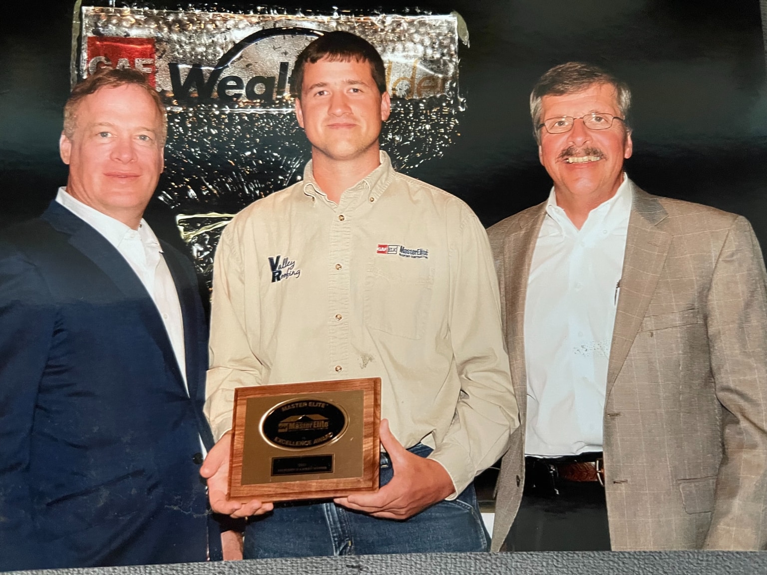 Anson Martin accepting our first Master Elite® Excellence Award from GAF Roofing.