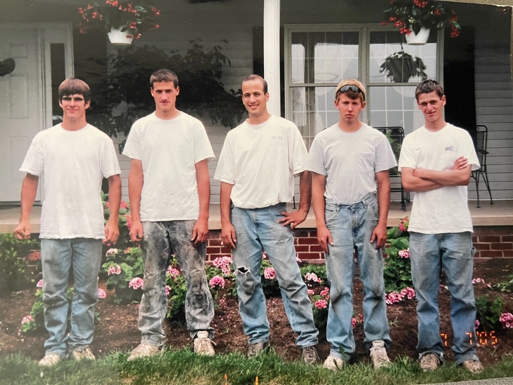 Valley Roofing & Exteriors original crew of five people standing in front of a home