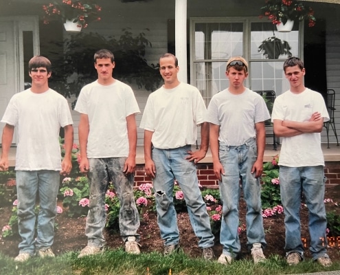 Valley Roofing & Exteriors original crew of five people standing in front of a home