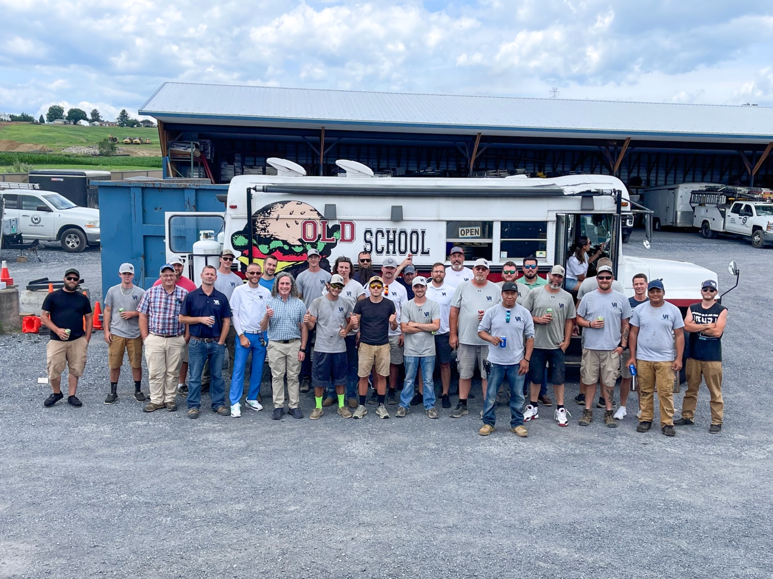 Valley Roofing & Exteriors team posing for photo in front of food truck after group training day