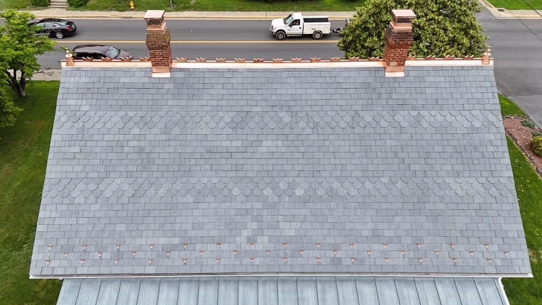 Front view of a custom-cut slate roof with copper detailing in Bridgewater, VA.