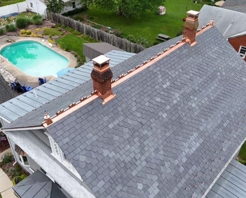 Custom-cut slate roof with copper detailing in Bridgewater, VA.