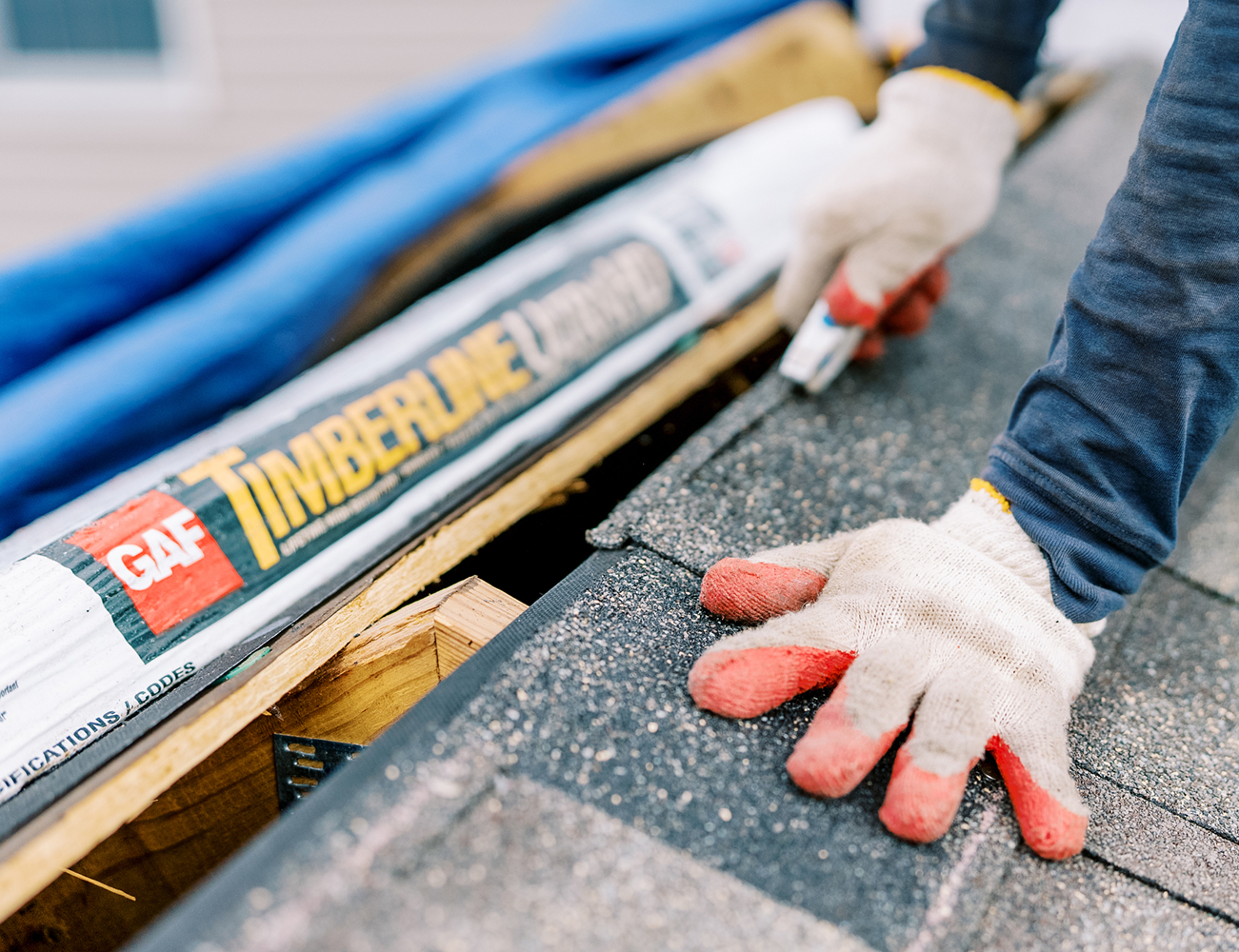 Close up of GAF Timberline roofing shingles being installed