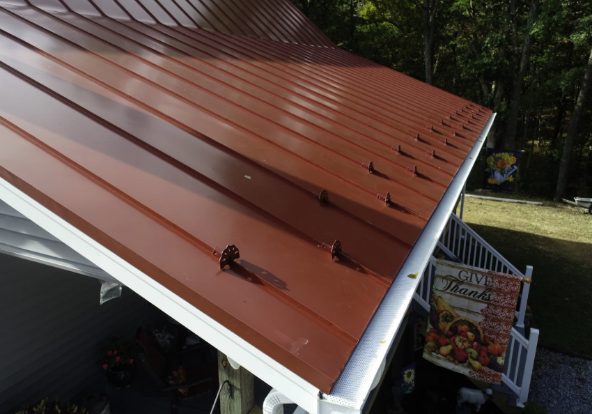 roof gutters gutters with guards on red metal roof